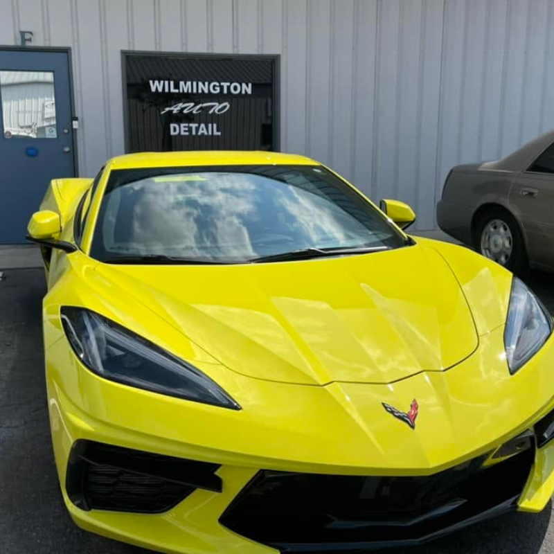 Bright yellow Chevrolet Corvette outside the Wilmington Auto Detail shop