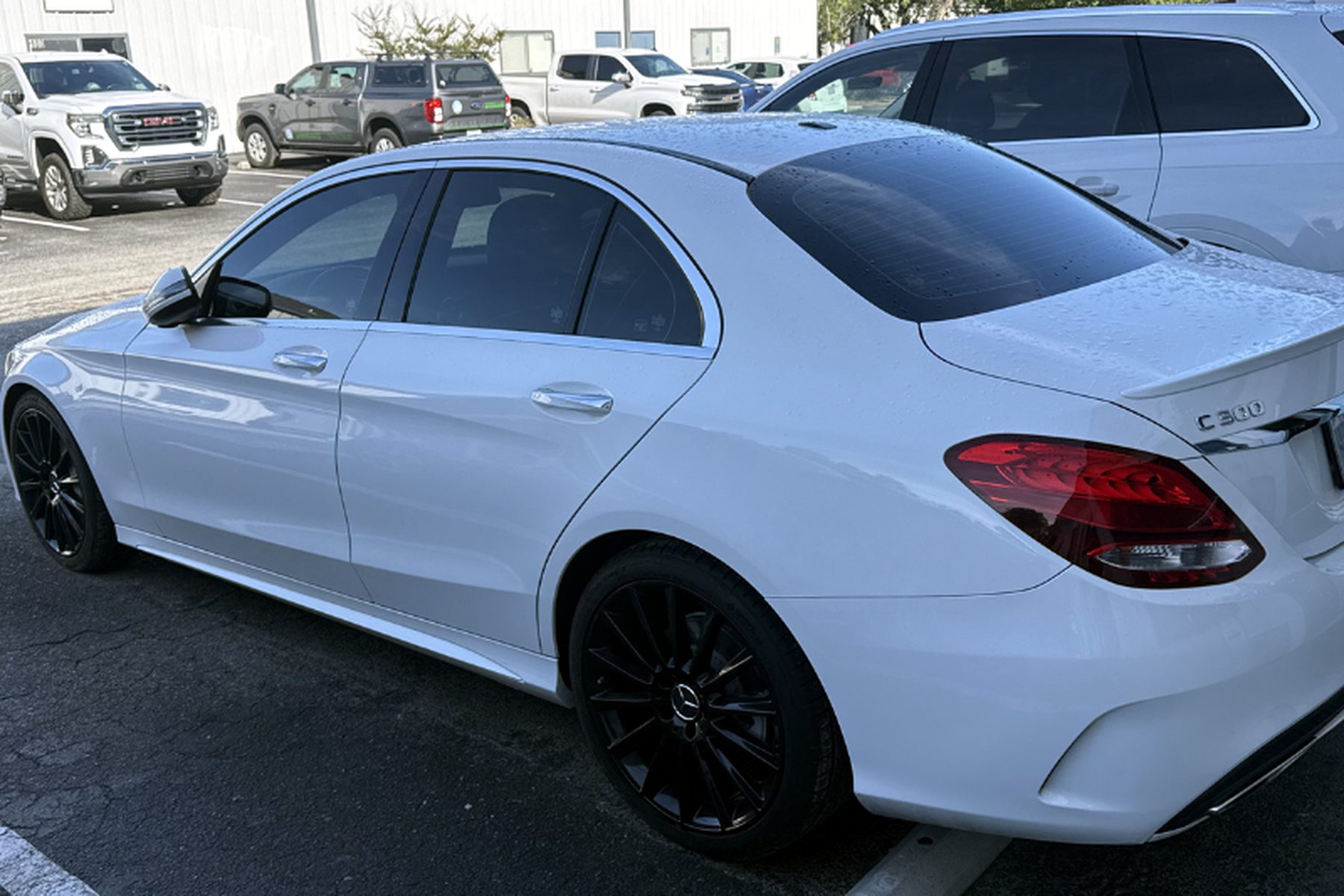 Freshly detailed white Mercedes C300 parked outside the Wilmington Auto Detail shop — car lot cleaning